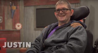 Smiling man with a disability.