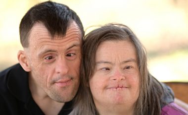 One smiling man and one smiling woman, each with a disability.