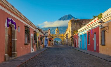 An image of a street in Guatemala, with colourful storefronts.
