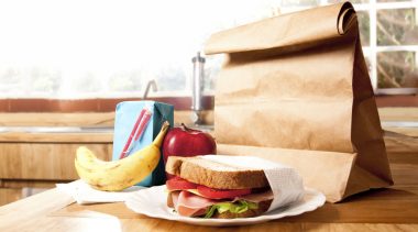 Brown paper bag lunch with healthy food