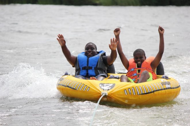 Two young happy boys on water raft