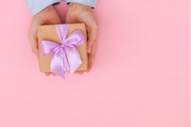 A pink gift in a child's hand